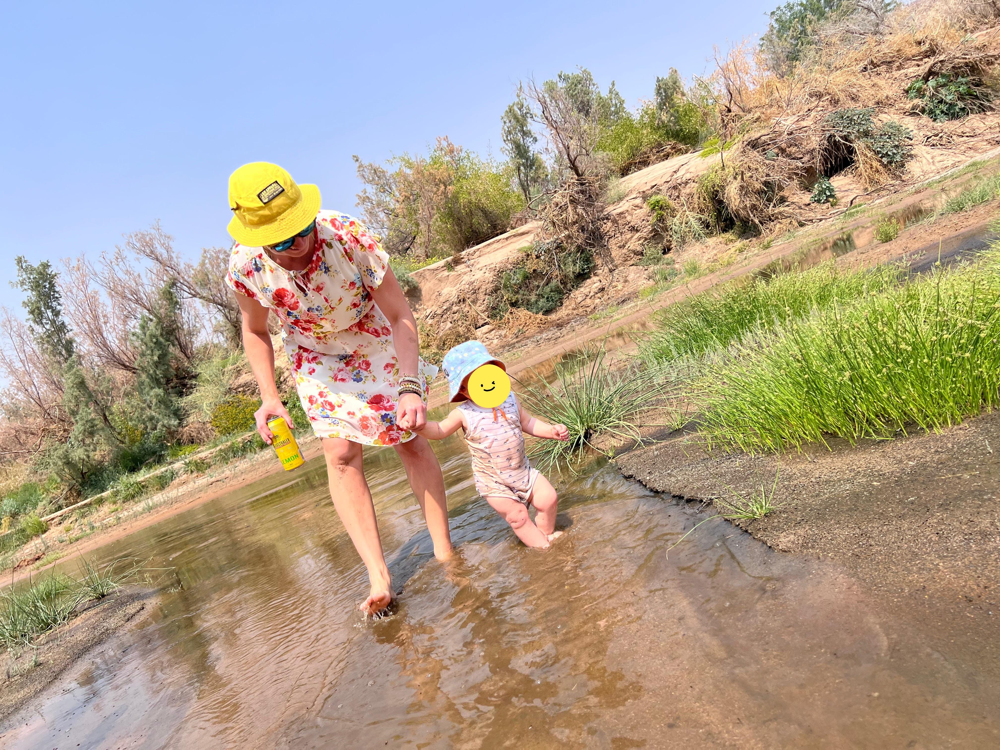 A vehicle stuck in the desert with a beautiful sunset