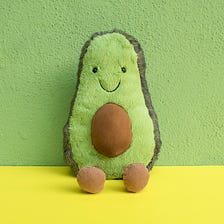 A funny, happy avocado stuffed toy