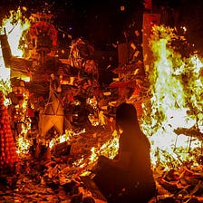 A woman burning joss paper during Ghost Month
