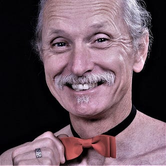 Mr Roberts, without his shirt but wearing a red bow tie