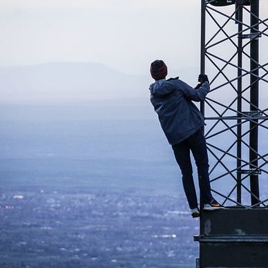 A person clinging to a platform above water
