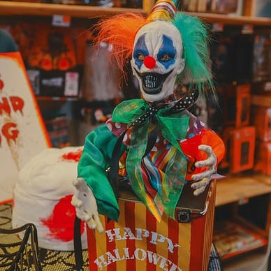 a creepy jack in the box outside of a store front.