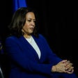 Democratic vice presidential candidate Kamala Harris sits and listen to Joe Biden’s remarks at the Alexis Dupont High School.