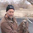 Brian Millsap, National Raptor Coordinator for the U.S. Fish & Wildlife Service, holding a juvenile female Cooper’s Hawk with VHF radio.