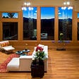 A clean and spacious living room with twilight view.