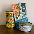 One can of Cento chickpeas and two types of store-bought vegan tuna substitutes, one in a pouch, one in a short can.