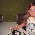 Girl with birthday cake showing Paul Stanley’s face