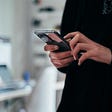 Person holding phone distracted from surroundings