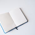 Open blank journal notebook with white background.