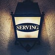 Serving is written on a lamp.