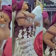 While dancing at someone's wedding, a Nigerian woman's overloaded melons fall out of her bra.