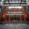 Photo of the front entrance to The New York Times building.