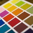 Flat squares of various colors arranged on a paper palette