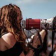 Girl with long hair using a megaphone