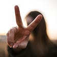 Woman holding up the peace sign