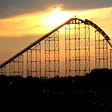 Photo of a roller coaster in a sunset.