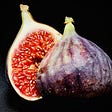 close up of a ripe fig, cut in half with seeds showing