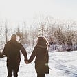 Guy and girl holding hands in the snow