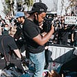 Image of a man taking pictures at a Black Lives Matter protest