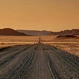 An image of a dirt road in Namibia, roads I encountered many times as a kid while cruising with the music together with my parents.
