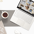 Flat lay of laptop and coffee cup and notebook