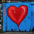 Wooden gate with red and blue heart paint