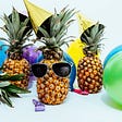 A header image from Unsplash — shows a pineapple with balloons