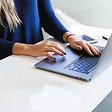 Woman typing on a laptop computer