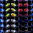 a wall of sunglasses in different colors and shapes