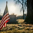 American flag by soldier’s tombstone