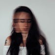 A young lady’s blurred moving face. Article is about Anxiety: what is it and how to control. Based on non-dual spiritual framework.