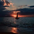 Sunset on the bay with sailboat
