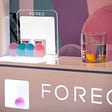 Foreo display with pods and a tablet behind it