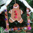 cardboard gingerbread man in craft stick gingerbread house ornament
