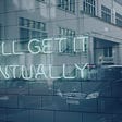 An image of a glass exterior of a building and the words ‘You’ll get it eventually’ printed on it.