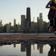 Person running by the water with the Sears Tower in the background