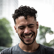 A happy-go-lucky man laughs with his eyes closed