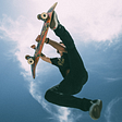 Entrepreneur skateboarding and performing trick in the air