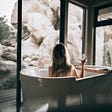 Woman relaxing in a bath with a view