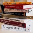 A stack of popular startup growth books.