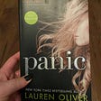 A photo of Ashley Broadwater holding Lauren Oliver’s book “Panic.”