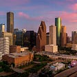 Picture of the city of Houston with tall buildings and highways
