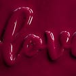 An all pinkish-purple image with the word ‘love’ highlighted in what looks like paint.