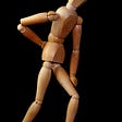 wooden figurine back pain