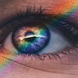 Persons’s eye with rainbow-light striped across it