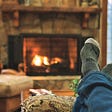 Man’s feet in front of the fire