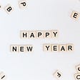 Tile letters on a white background spelling out Happy New Year