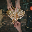 Photo of people’s hands using tarot cards.