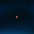 Red moon in darkness of universe