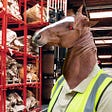 A horse-headed “reverse-centaur” whose eye has been replaced by the glowing eye of HAL9000 from 2001: A Space Odyssey. They are wearing a hi-viz vest and posed in shelving-aisles of an industrial warehouse.